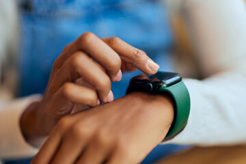 Close-up of a female using her smartwatch, calling someone.