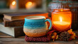 © rorozoa - A vibrant crochet-covered ceramic cup with a backdrop of books and candle light