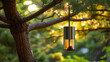 Sleek modern bird feeder with metallic finish hanging in a pine tree