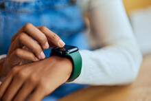 Close-up Of A Black Female Using A Smartwatch, Wearing Around The Wrist.