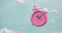 Pink Alarm Clock Closeup With Clouds. Pink Clock Swings Like A Pendulum From Side To Side, Wake-up Time Morning On Blue Background. Concept.4k Loop. Generative AI