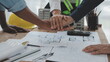 © Sutthicha - Construction and structure concept of Engineer or architect meeting for project working with partner and engineering tools on model building and blueprint in working site, contract for both companies.