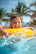 © MNStudio - Child playing in swimming pool with colorful floating toy. Little child having fun on family summer vacation in tropical resort. Beach and water toys.