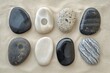 Eight smooth water worn pebbles on sand