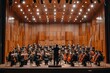 A large orchestra is performing on stage with the conductor in front of them