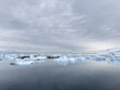 © Vladimir Drozdin - A huge high breakaway glacier in the southern ocean off the coast of Antarctica, the Antarctic Peninsula, the Southern Arctic Circle, azure water, cloudy weather