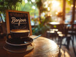 Coffee cup in a cafe in morning light and sign with written french word Bonjour meaning Hello. 