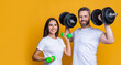 © be free - Athlete couple with barbell and dumbbell. Family sport. Fitness gym. Couple of strong sporty sportswoman and sportsman. Woman man do sport training exercise isolated on yellow. Banner