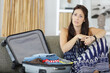woman with suitcase looking worried