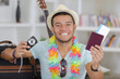 young man showing his digital camera and passport