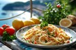 Close-up of a plate of spaghetti with shrimps surrounded by lemons and herbs on a wooden table. Cozy summer terrace overlooking picturesque Mediterranean seascape.