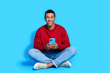 Photo of nice attractive man blogger dressed trendy red clothes use modern device apple ipone isolated on blue color background