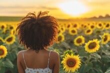 Girl With Curly Hair Admiring A Field Of Sunflowers At Sunset
