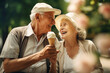 © edelweiss7227 - An elderly couple eating ice cream in summer park