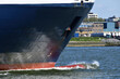 Close up of the bow of a cargo ship with the bulbous bow pushing aside the water in the Nieuwe Waterweg near Maassluis, The Netherlands