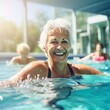 Active mature women enjoying aqua gym class in a pool, healthy retired lifestyle with seniors doing aqua fit sport