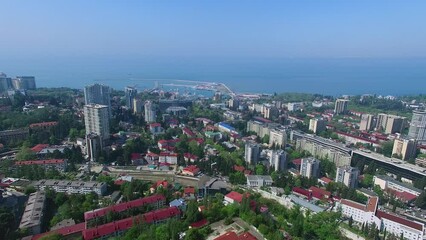 Wall Mural - Seascape and coastal city with sea port at spring sunny day. Aerial view