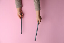 Little Kid Holding Drumsticks On Pink Background, Top View