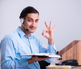 Wall Mural - Call center operator working at his desk