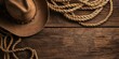 Cowboy Hat and Rope on Wooden Table