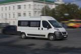 Fototapeta Miasto - Minibus Goes on the City Street