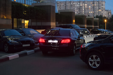 Wall Mural - Cars in a parking lot at night in the city