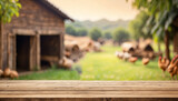 Empty wooden table for product display with blurry chicken farm background