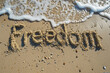 Ultimate Freedom - the word 'Freedom' written on beach sand Gen AI