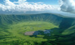 Elevated view of floor of Ngorongoro Crater from the southern edge of the crater. Looking toward Lerai Forest and the alkaline crater lake, Lake Magadi, with clouds covering the rim on other side.