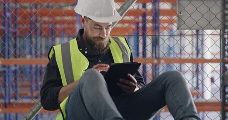 Poster - tablet, relax and man on break in factory or warehouse for internet, engineering or communication. Storage, social media or contractor with technology for job logistics, construction or online news