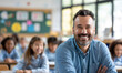 © Natali - Portrait of smiling male teacher in a class at elementary school looking at camera with learning students on background