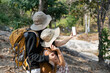 © itchaznong - Happy LGBT Lesbian couple selfie with mobile while Hiking with Backpacks in forest Trail. LGBT Lesbian Couple Hikers with backpacks walks in mountains in vacation