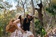 © itchaznong - Happy LGBT Lesbian couple Travelers Hiking with Backpacks in forest Trail. LGBT Lesbian Couple Hikers with backpacks walks in mountains in vacation