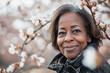 Middle aged black woman enjoying spring blossoms Spring portrait