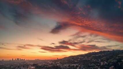 Fototapete - Red sunset over the city of Los Angeles cityscape. Aerial hyperlapse timelapse.