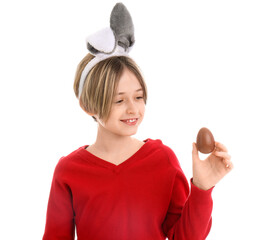 Sticker - Cute little boy in bunny ears with chocolate egg on white background. Easter celebration