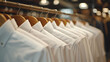 White men shirts hanging on rack in a row. Men clothing shop boutique salon. generative ai