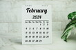 February 2024 monthly calendar on chalkboard for planning and management