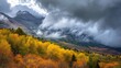 A short break in the clouds illuminates the fall foliage as it rains over Mountain