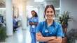 © Vivid Pixels - Smiling female healthcare worker in a medical office