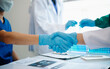 © laddawan - Doctor handshake and partnership in healthcare, medicine or trust for collaboration, unity or support.Team of medical experts shaking hands