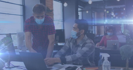 Poster - Image of glowing light trails over men using tablet wearing face masks