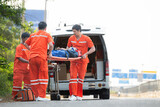 Fototapeta  - The paramedic  is assisting an injured man in an emergency situation on the road.