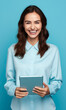 © Moon Story - Business Caucasian Woman Worker Smiling and Holding Digital Tablet: Professional Standing Over Blue Background