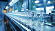 Medical vials on production line at pharmaceutical factory. Pharmaceutical machine working pharmaceutical glass bottles production line.
