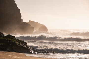 Wall Mural - Big ocean waves crashing on the rocks in Nazare, Portugal.