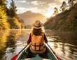 © Noncharu - Woman canoeing on a river can be seen from behind