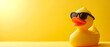 Υellow rubber duck toys wearing sunglasses isolated on yellow background. copy space, mock up. top view.