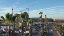 The New Convention Center Being Build In Chula Vista California, Drone Rising From Behind Palm Trees.