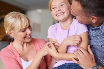 Wall Mural - Family, laughing and parents tickling daughter in living room of home for playful bonding together. Kids, happy or love with mother, father and girl child playing in apartment for comedy or humor